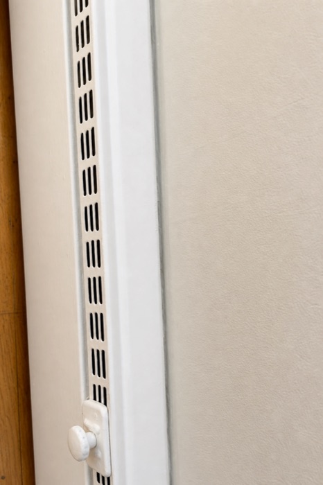 Clean white baseboard heater vent after a NeatNow cleaning